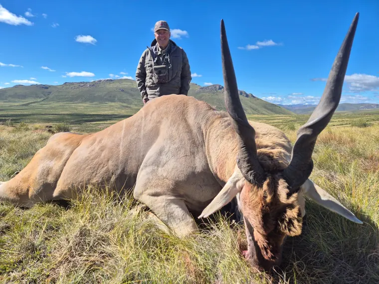 Hunter with a mature plains game trophy in open Eastern Cape country