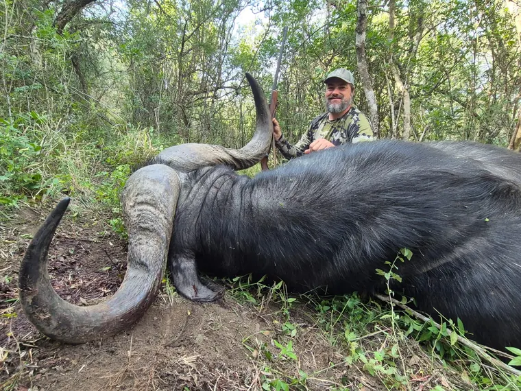 Hunter with a blue wildebeest trophy in Eastern Cape brush country