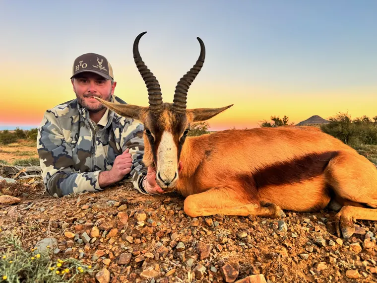 Hunter with a plains game trophy at sunset in the Eastern Cape