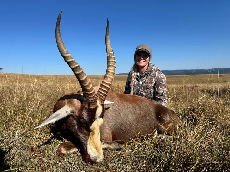 Hunter with a mature antelope trophy beneath a bright Eastern Cape sky