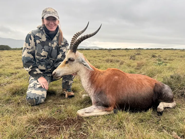 Hunter with a small antelope trophy in open Eastern Cape hills