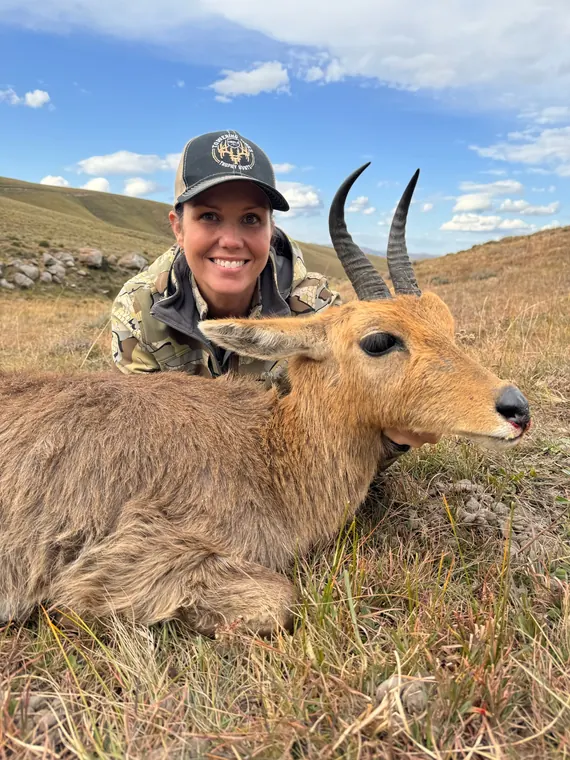 Hunter with a mature plains game trophy in South African grassland