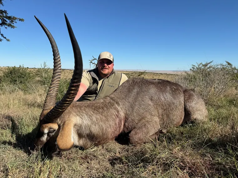 Hunter with a mature antelope trophy in Eastern Cape grassland
