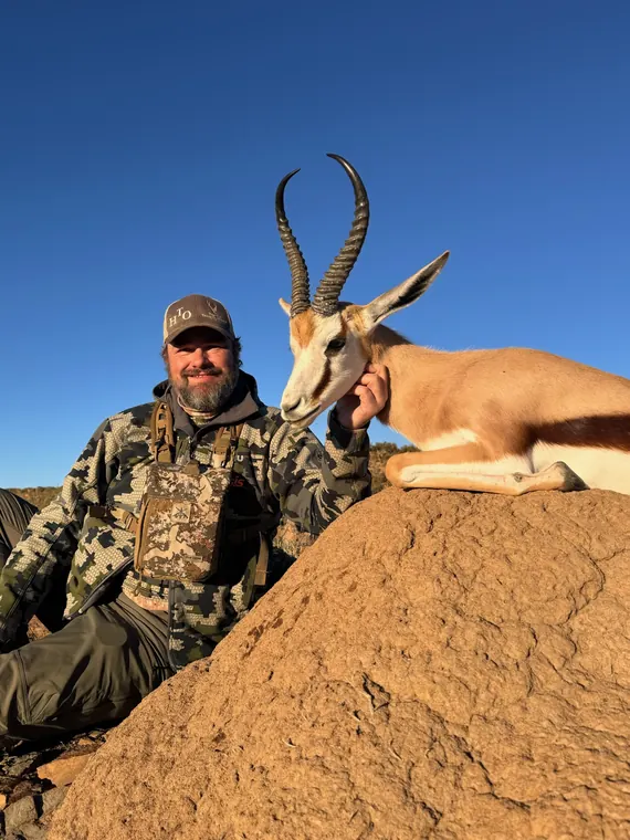 Hunter with a mature plains game trophy in warm South African light