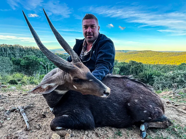 Hunter with a mature spiral horned trophy in the Eastern Cape