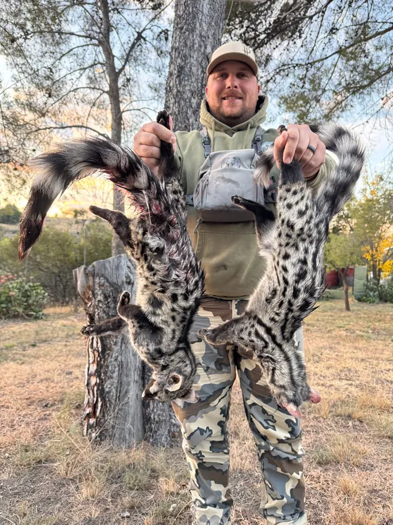 Hunter holding a spotted wild cat trophy in South Africa