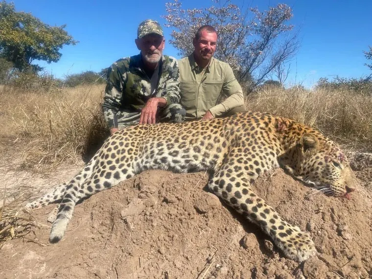 Hunters with a leopard from the Botswana album