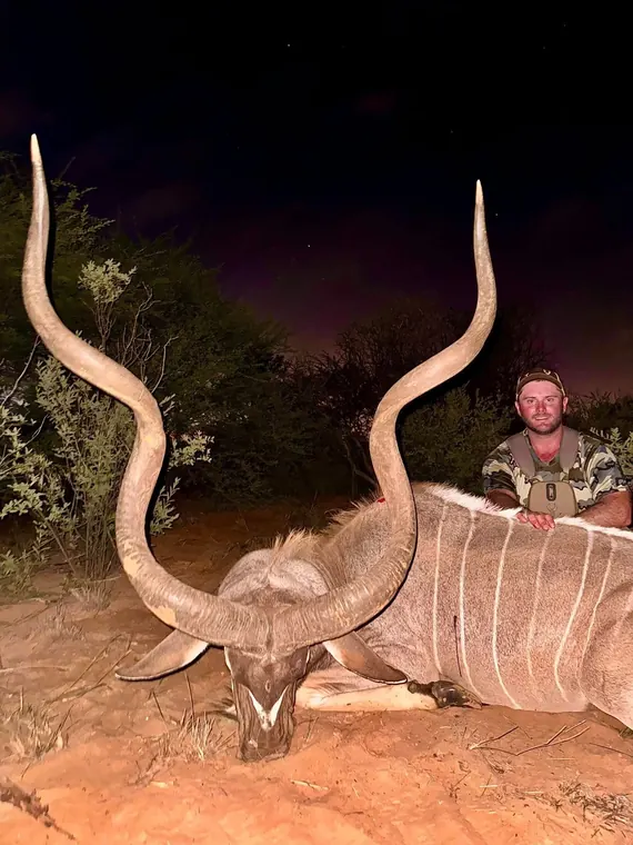 Hunter with an antelope at night