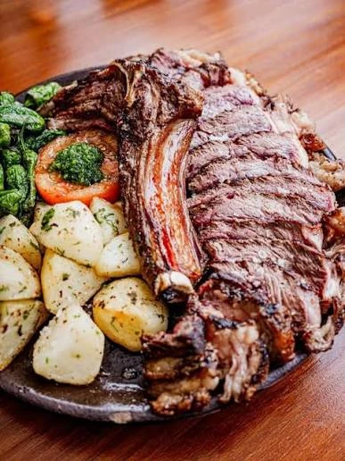 Grilled steak served with potatoes and vegetables