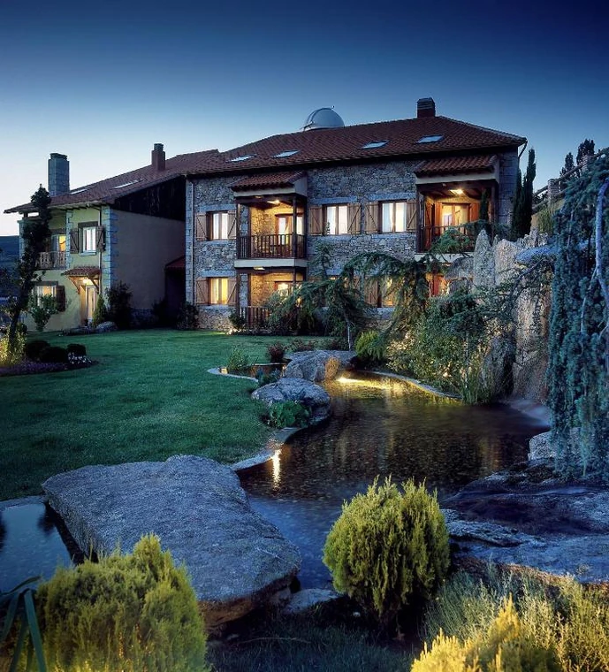 El Milano Real hotel and illuminated gardens at dusk, Spain