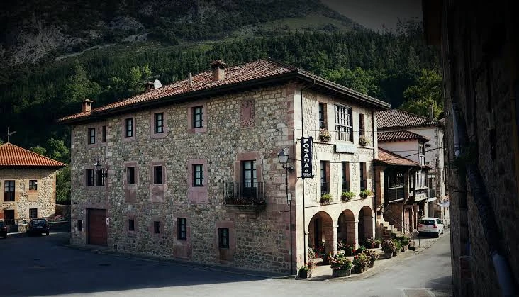 Stone facade and arched entrance of Posada de Fidel, Spain