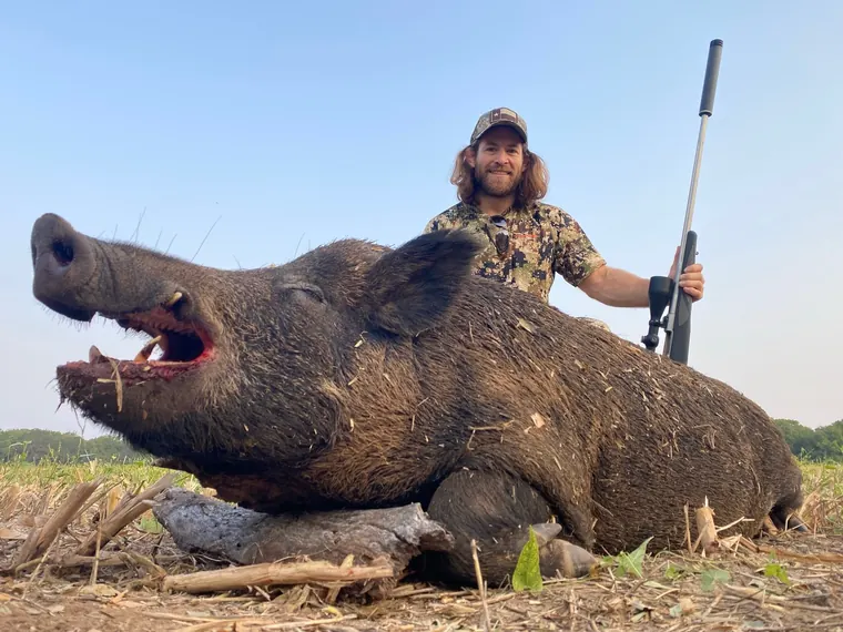 Hunter with a feral hog in Dublin ranch country