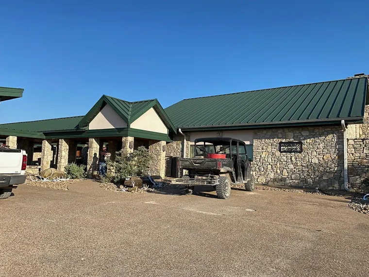 Stone lodge with a green roof at the Dublin hunting property