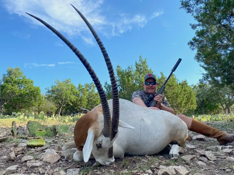 Hunter with a scimitar horned oryx in Dublin ranch country