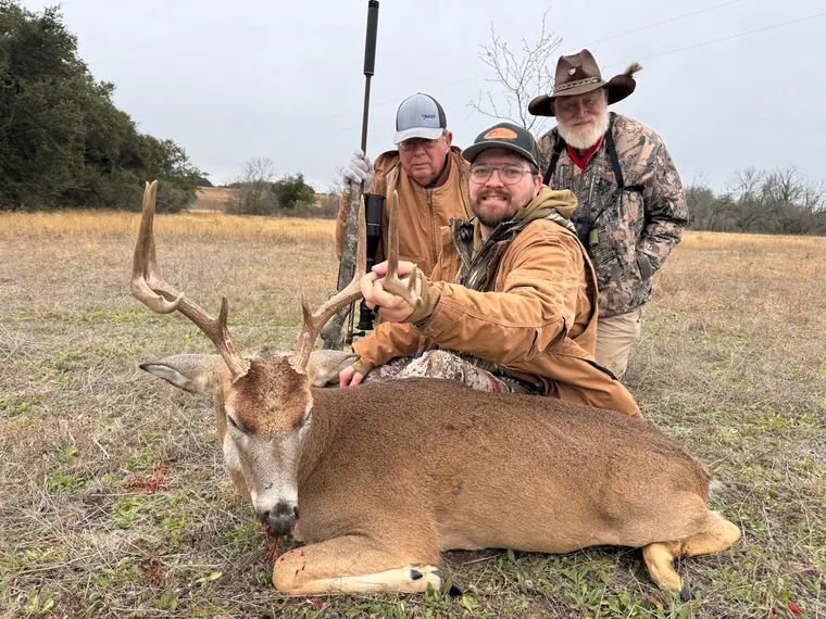 Three hunters with a whitetail buck in Dublin, Texas