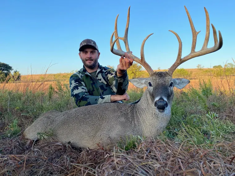 Hunter with a whitetail buck in Dublin, Texas